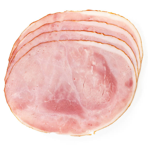 Multiple slices of premium ham laid out on white background