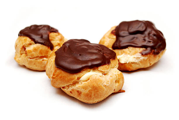 Creme Puffs, White Filling Topped with Chocolate These were made by a bakery in St. Louis, Missouri. They were isolated with a white background for easy cropping. choux pastry photos stock pictures, royalty-free photos & images