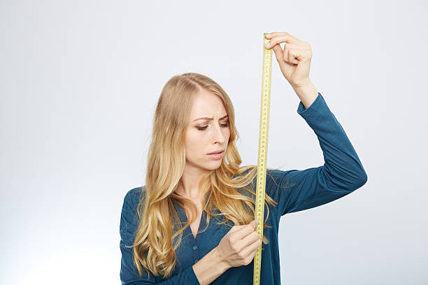 istock young woman with a tape measure 471710120