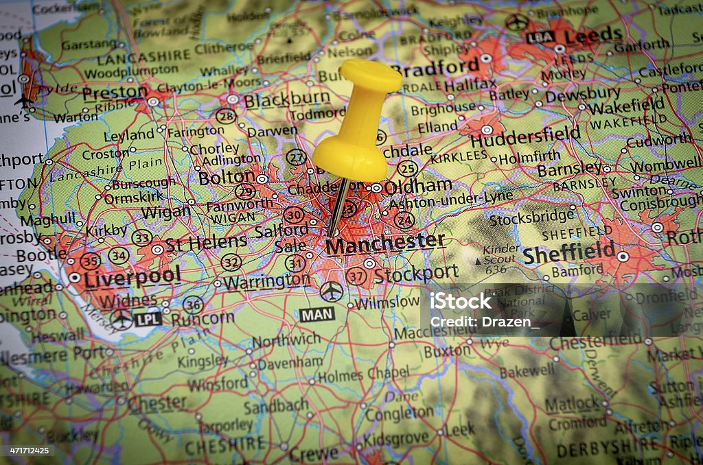 Destination Manchester, UK, on geographical map in close up image Detail of the geographic map with yellow pin Map Stock Photo