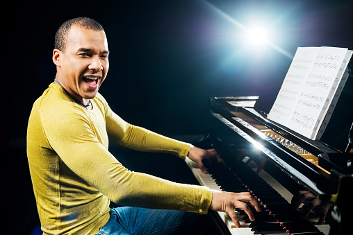 Man singing and playing the piano.