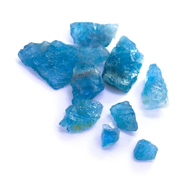 istock Raw blue aquamarine rocks on white background. 471713163
