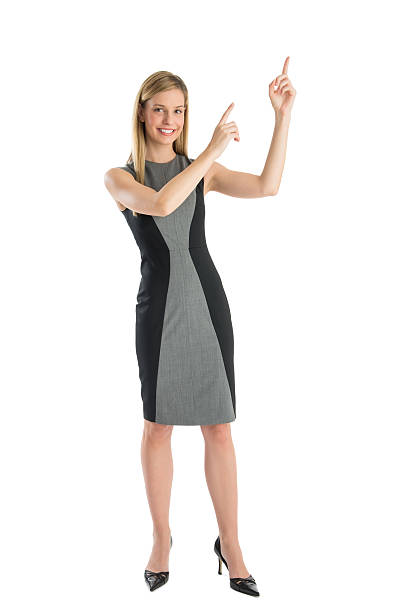istock Businesswoman Pointing Upwards Against White Background 471713405