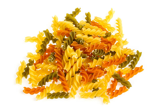 istock Uncooked pasta fusilli in different colours, white background 471713925