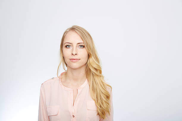 istock woman is standing with a rose blouse. isolated on white 471715984