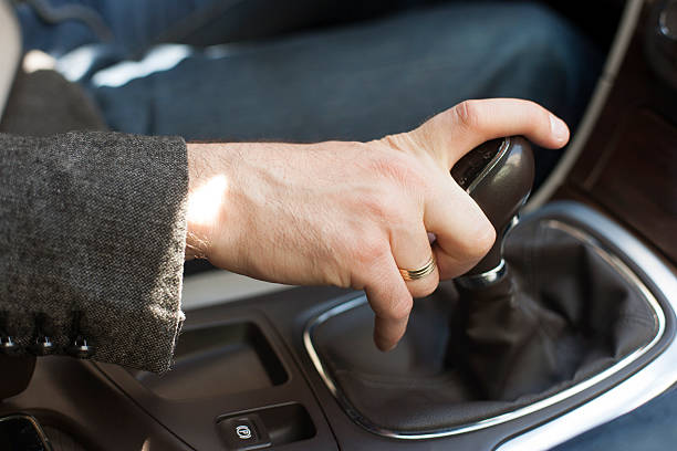 istock Car interior, elegant man, hand on a gear shift lever 471716350
