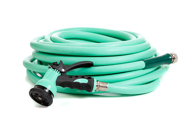 istock Green garden hose on a white background 471717327