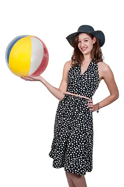 Beautiful young woman holding a beachball