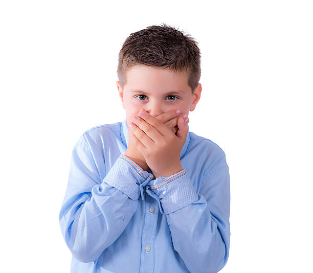 istock child covering his mouth 471717918