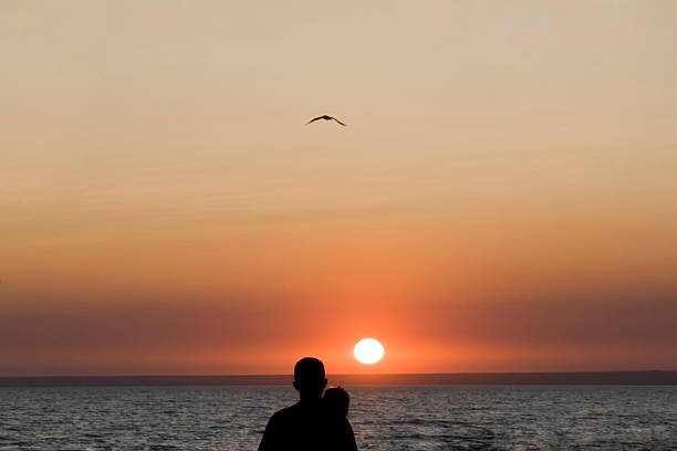 Silhouette man and woman again sunset