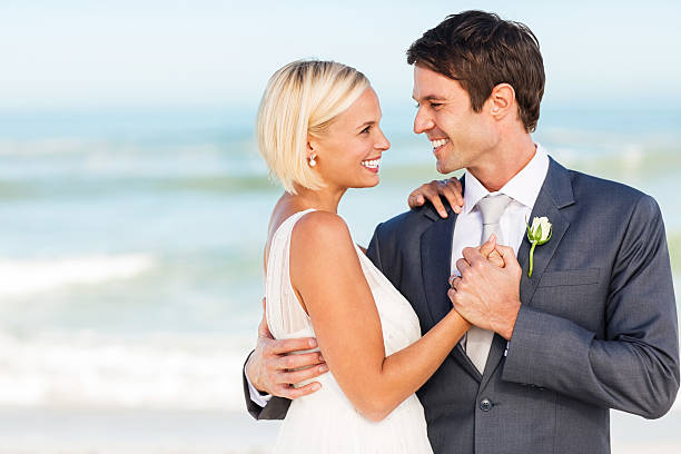 istock Bride And Groom Holding Hands On Beach 471719665