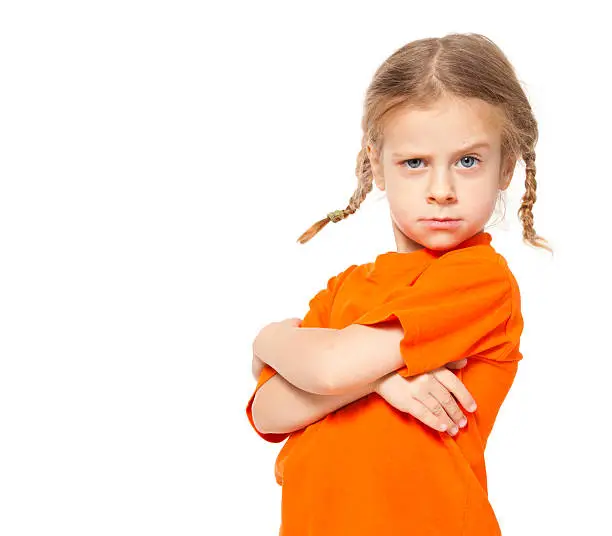 Little girl at yellow jeans. Child on white background