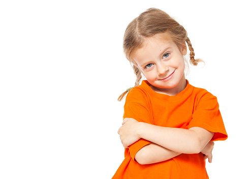 Little girl at yellow jeans. Child on white background