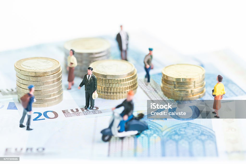 Miniature people on Euro banknotes and coins Miniature people on 20 Euro banknotes and coins close-up European Union Currency Stock Photo