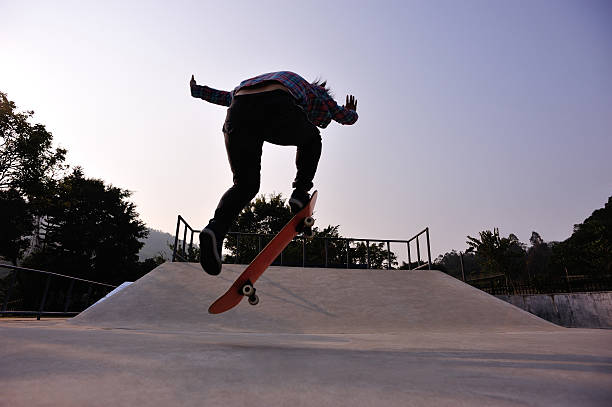 istock skateboarder doing ollie at sunrise skatepark 471720670