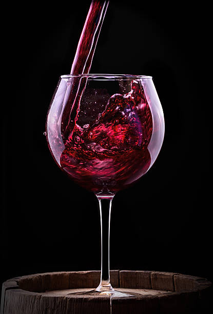 istock Elegant red wine glass in black background 471721257