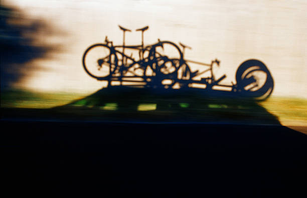 The shadows of three mountain bikes on a roof rack while on a Colorado road trip.
