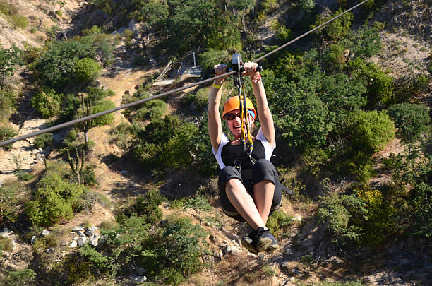 młoda kobieta na suwak wyściółka - zip lining zdjęcia i obrazy z banku zdjęć