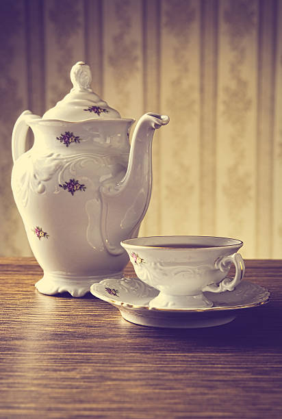 istock Old-fashioned vintage jug with tea with wallpaper background 471722494