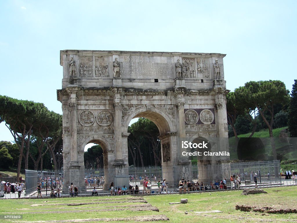 Rome, Arch Of Constantine under blue sky, Italy Arch of Constantine is a three-gate triumphal arch next to the Colosseo Colosseum the amphitheater in Rome, beautiful capital Rome in Italy under blue skies with white clouds, it is summer time for holidays and many tourists, there is a lot of history to experience the amphitheater, the ancient architecture of the Arena, the famous Colosseum, the historic Roman Forum, the tense staircase and the Trevi Fountain are attractions and a sight of ancient culture and ornate art,  the river Tiber ItalianTevere is the pride of every Roman, the Catholic Church shows itself in Rome with St. Peter's Basilica, Roman ancient basilica, basilica papale di san pietro in vaticano, the castel sant'angelo, the cathedral church, valuable history and heritage of the people, dome characterize the urban landscape of Rome 2015 Stock Photo