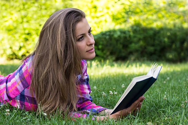 istock Beautiful young female with book in the hands 471722665