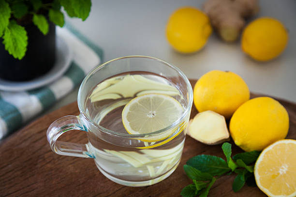 istock Lemon Ginger Tea with wooden Background 471723216