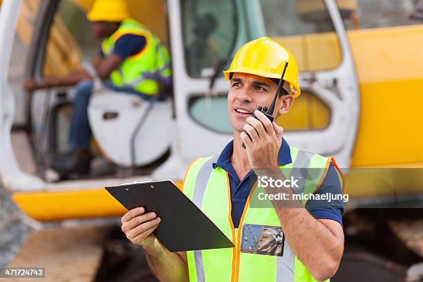 Construction Foreman Talking On Walkietalkie Stock Photo - Download Image Now - CB Radio, Occupation, Office