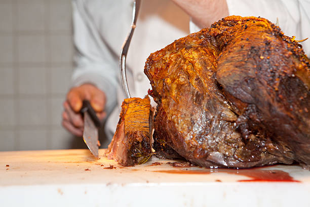 Roast meat is being carved