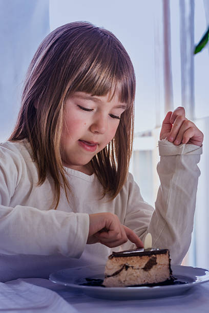 istock little girl with cake 471726730