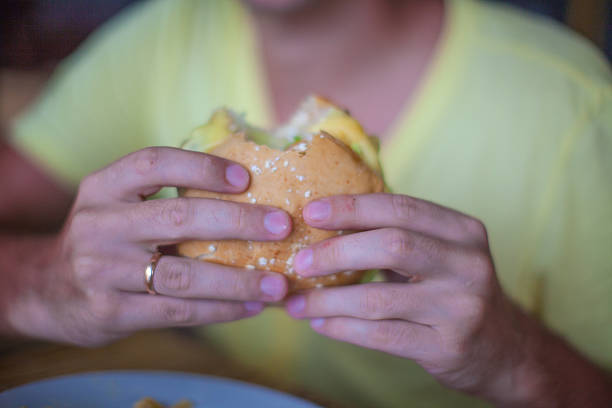 istock Close up burger in man's hands on the breakfast 471729835