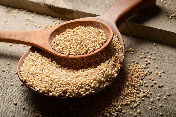 A picture of grains in a wooden spoon stock photo