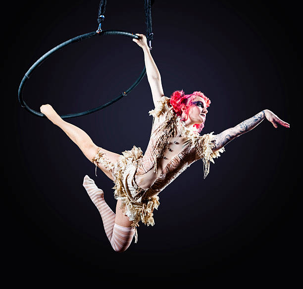 circus performer hoop - zirkusveranstaltung stock-fotos und bilder