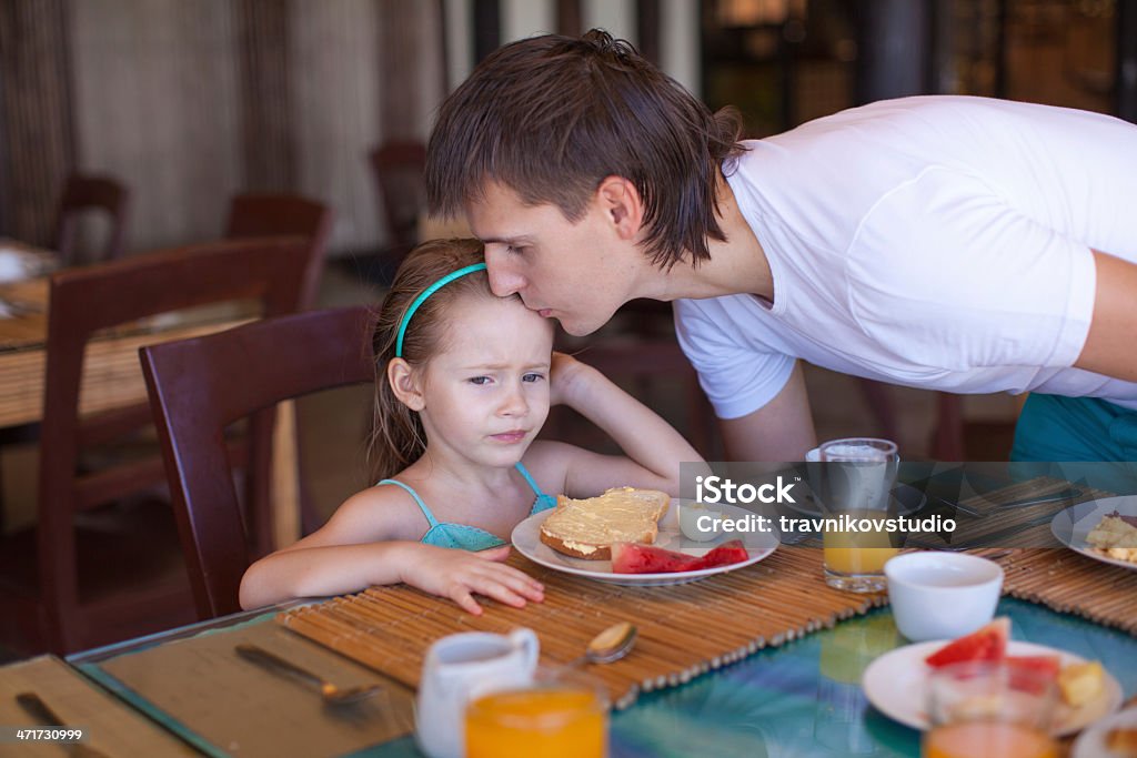 Father kiss his daughter before breakfast in the restaurant Backgrounds Stock Photo