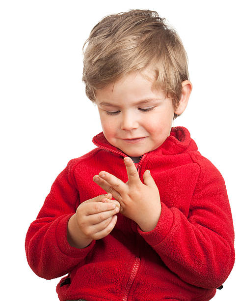 Toddler boy counting with fingers stock photo