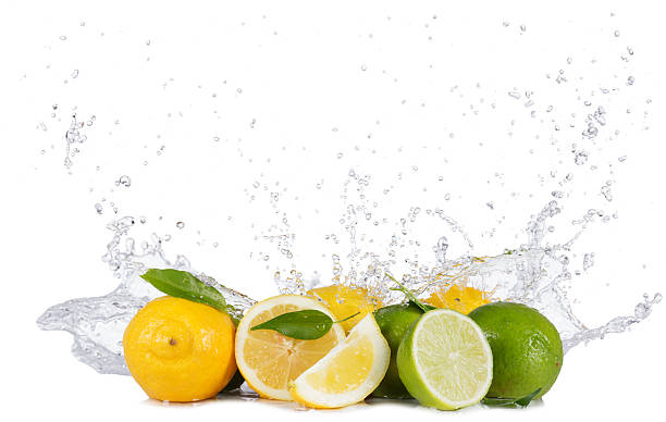 istock Lemons and limes with water splashes on white 471735328
