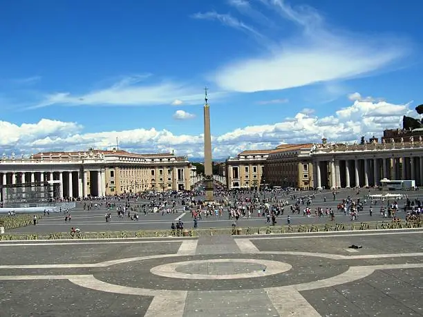 Square of St. Peter's Basilica - Basilica Papale di San Pietro in Vaticano, beautiful capital Rome in Italy under blue sky with white clouds, it is summer time for holidays and many tourists, there is a lot of history to experience the amphitheater, the ancient architecture of the Arena, the famous Colosseum, the historic Roman Forum, the tense staircase and the Trevi Fountain are attractions and a sight of ancient culture and ornate art,  the river Tiber ItalianTevere is the pride of every Roman, the Catholic Church shows itself in Rome with St. Peter's Basilica, Roman ancient basilica, basilica papale di san pietro in vaticano, the castel sant'angelo, the cathedral church, valuable history and heritage of the people, dome characterize the urban landscape of Rome