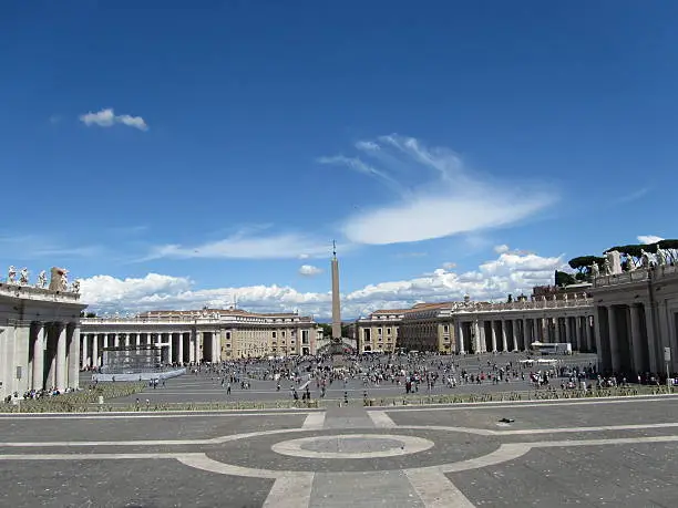 Square of St. Peter's Basilica - Basilica Papale di San Pietro in Vaticano, beautiful capital Rome in Italy under blue sky with white clouds, it is summer time for holidays and many tourists, there is a lot of history to experience the amphitheater, the ancient architecture of the Arena, the famous Colosseum, the historic Roman Forum, the tense staircase and the Trevi Fountain are attractions and a sight of ancient culture and ornate art,  the river Tiber ItalianTevere is the pride of every Roman, the Catholic Church shows itself in Rome with St. Peter's Basilica, Roman ancient basilica, basilica papale di san pietro in vaticano, the castel sant'angelo, the cathedral church, valuable history and heritage of the people, dome characterize the urban landscape of Rome