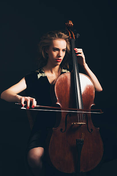 istock Young woman playing in a classical concert 471736540