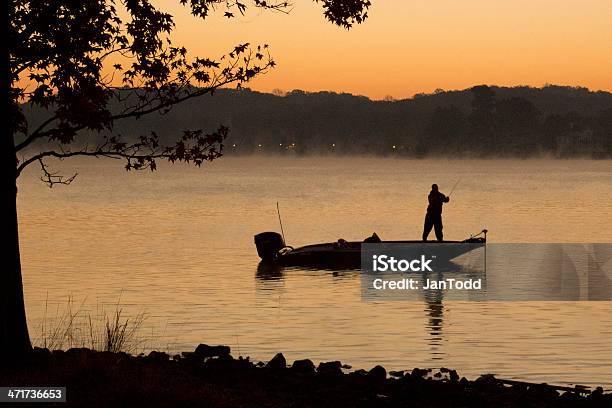 Bass Fisherman On Lake At Dawn Stock Photo - Download Image Now - Fishing, Nautical Vessel, Fishing Boat