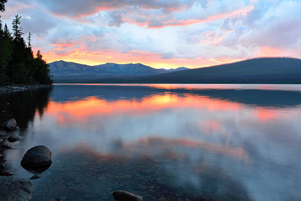 istock beautiful red sunset into the Mountains and McDonald lake 471738176