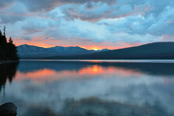 istock beautiful red sunset into the Mountains and McDonald lake 471738188