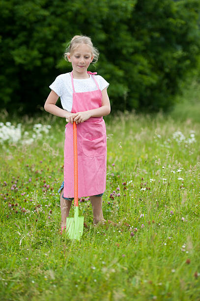 istock gardening: girl with rake, outdoors 471738703