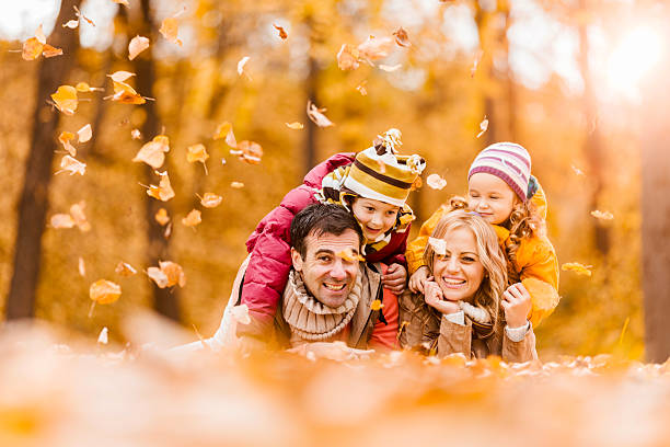 istock Happy family lying down in autumn park. 471740838