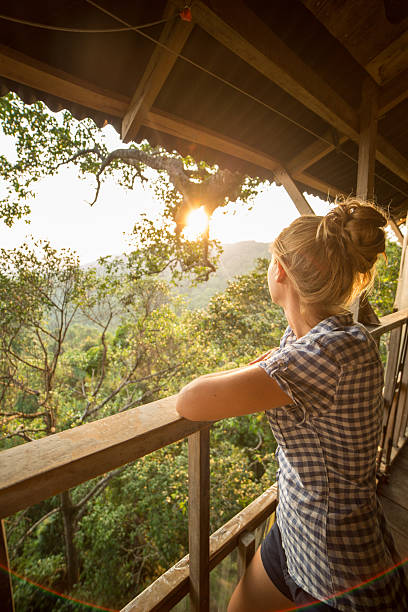 istock Young woman looking at sunset in nature 471740994