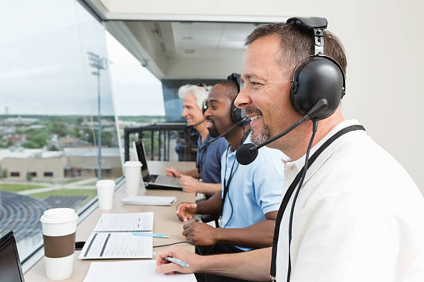 istock Sports commentators covering game from stadium press box 471741189