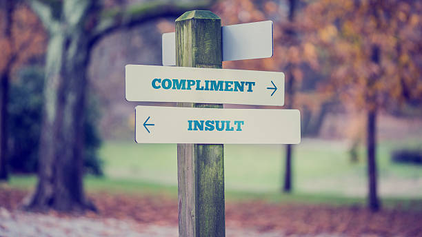 istock Words Compliment and Insult in a conceptual image 471741558