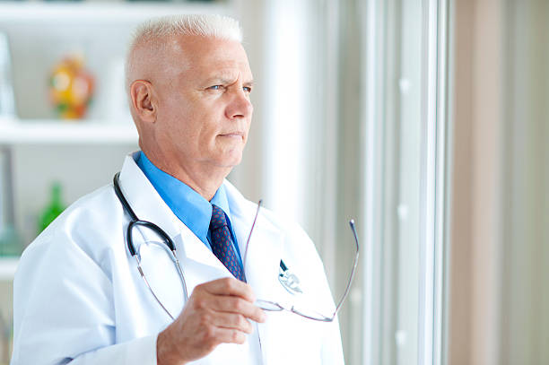 istock A male physician looking out the window 471741729