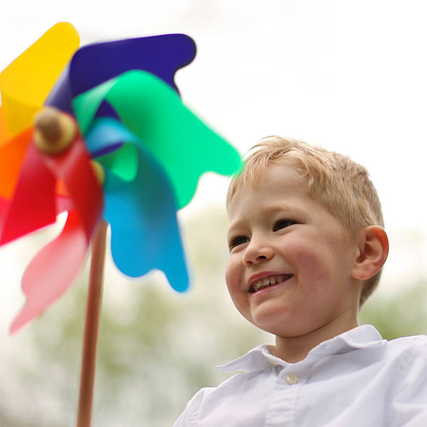 istock Smiling Little Boy Playing with Pinwheel 471744666