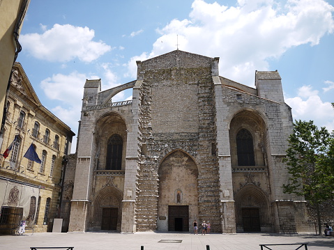 Tourists in front of the Cathedral of Saint Mary Magdalene at Saint-Maximin-la-Sainte-Baume, Southern France. Photo taken on July 2013. 40 km east of Aix-en-Provence, this church dedicated to Mary Magdalene is housing her remains in the crypt.