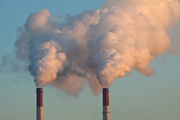 istock Two pipes polluting the air 471745652